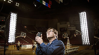 Steven G. Smith photographer works on lighting a portrait. 